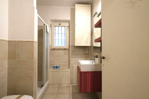a small bathroom with a sink and a shower at Wine Apartments Florence Malvasia in Florence