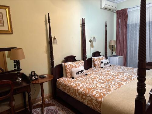 a bedroom with a bed and a table at 45 on Mendelssohn in Johannesburg