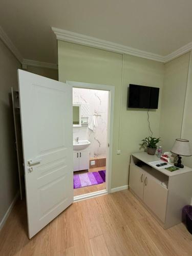 an open door to a room with a sink at Duman House in Almaty