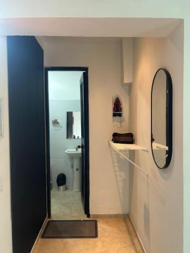 a bathroom with a mirror and a sink at Tolu - Caribbean apartment in Santiago