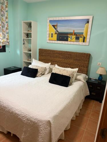 a bedroom with a large white bed with two pillows at Apartamento en Valle del Este in Vera