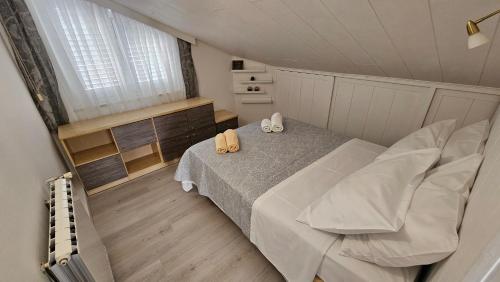 a bedroom with a bed with two pillows on it at Lopar Lidija in Lopar