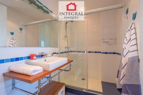 a bathroom with a sink and a shower at Infinite View Palamós in Palamós