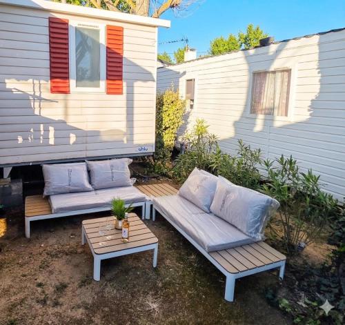 a patio with two couches and a table at Les sables du midi in Valras-Plage