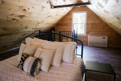 a bedroom with a bed with pillows on it at Pine Creek Farm in Burkeville