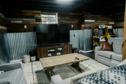 a living room with a tv and a coffee table at Pine Creek Farm in Burkeville