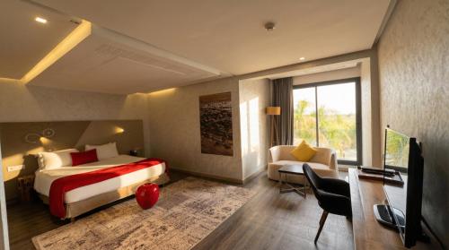 a hotel room with a bed and a desk and a couch at Villa AG Marrakech in Marrakesh