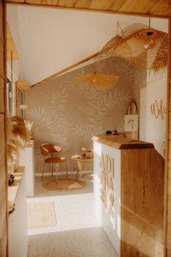 a kitchen with a table and an umbrella on the wall at Adishatz Motel in Biscarrosse