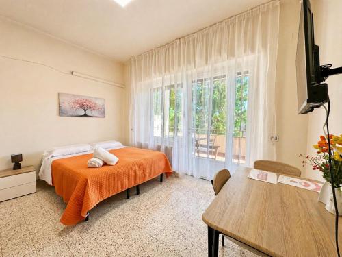 a bedroom with a bed and a large window at Oasi Venus Perugia e Assisi in Ponte San Giovanni