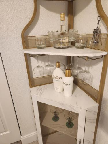 a white shelf with bottles and glasses on it at Comfy hideaway in Hollywood