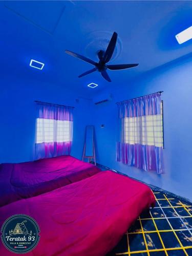 a bedroom with a bed with a ceiling fan at Teratak 93 in Karak
