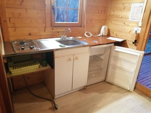 a kitchen with a sink and a stove at Saut du moine in Simiane-la-Rotonde