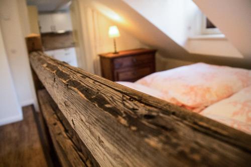a bedroom with a bed with a wooden head board at Ferienwohnungen Finkenherd 5 in Quedlinburg