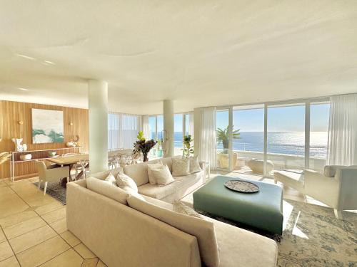 a living room with a couch and a table at Bay Reflections Camps Bay Luxury Serviced Apartments in Cape Town