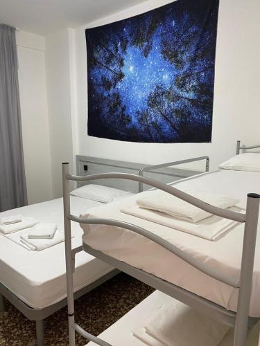 a bed in a room with a painting on the wall at Pernottamento Madonna del Pino Cervia in Cervia