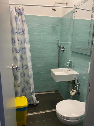 a bathroom with a sink and a toilet and a shower at Pernottamento Madonna del Pino Cervia in Cervia