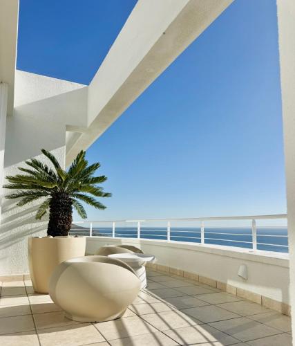 a balcony with a view of the ocean at Bay Reflections Camps Bay Luxury Serviced Apartments in Cape Town