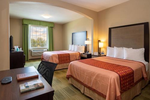 a hotel room with two beds and a table at Cotulla Express Inn in Cotulla