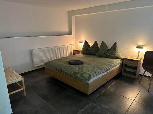 a bedroom with a bed and a chair and a table at Hotel Krone in Wassen