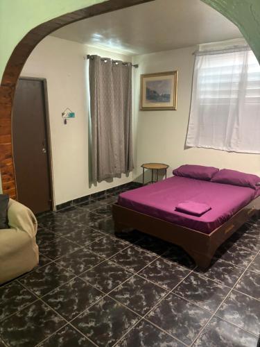 a bedroom with a purple bed in a room at Joe's Studio in San Juan