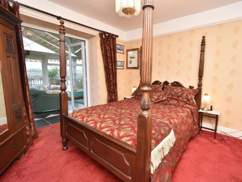 a bedroom with a bed with a red comforter at 1 Bed in Goodwick oc-fb274 in Goodwick