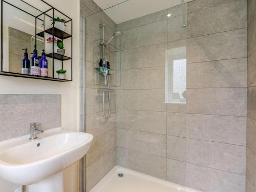 a bathroom with a shower and a sink and a glass shower door at 1 Bed in Corsham oc-83690 in Box