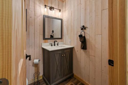 a bathroom with a sink and a mirror at Hillside Happiness GameRoom Grill Firepit MORE in Sevierville