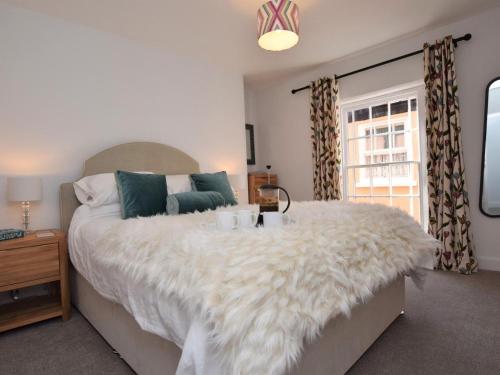 a bedroom with a large bed and a window at 2 Bed in Bideford oc-75307 in Appledore
