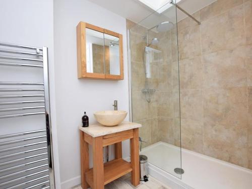 a bathroom with a sink and a glass shower at 2 Bed in Bideford oc-75307 in Appledore