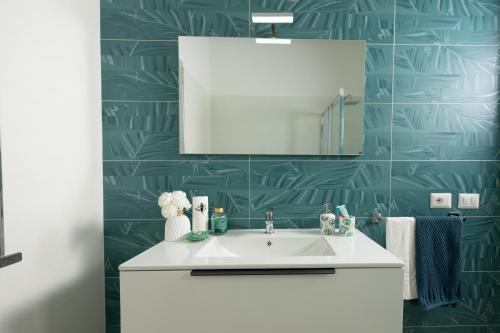 a bathroom with a white sink and a mirror at Villetta Caterina in Procida
