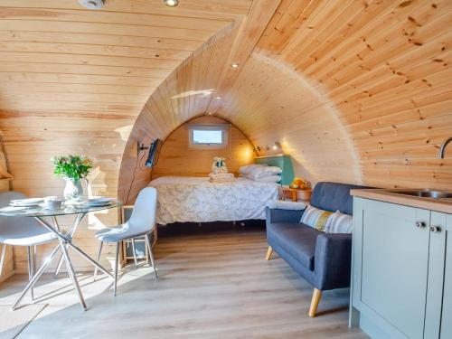 a bedroom with a bed and a table in a room at 1 Bed in Conwy oc-95221 in Conwy