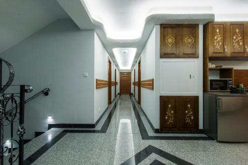 a hallway of a house with a staircase and a kitchen at Dom Wczasowy Na Szczycie in Zakopane