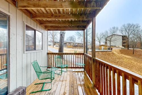 two chairs sitting on a porch of a house at Escape to Notch Estates in Branson West