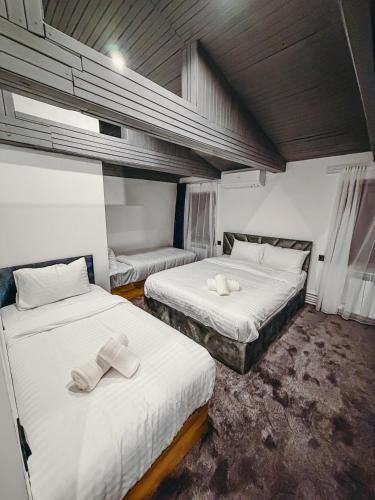 a bedroom with two beds with towels on them at Pushkin Hotel Yerevan in Yerevan