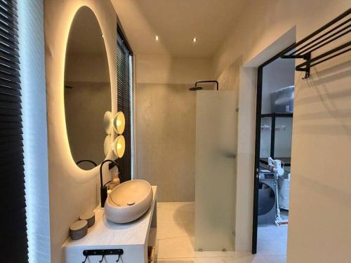 a bathroom with a toilet and a mirror at MoonLight Villa - 3BR Tropical Pool Retreat in Ko Phangan