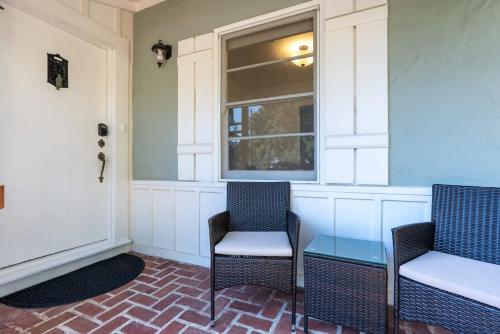 two chairs and a table in front of a window at Coastal Charm in Santa Cruz