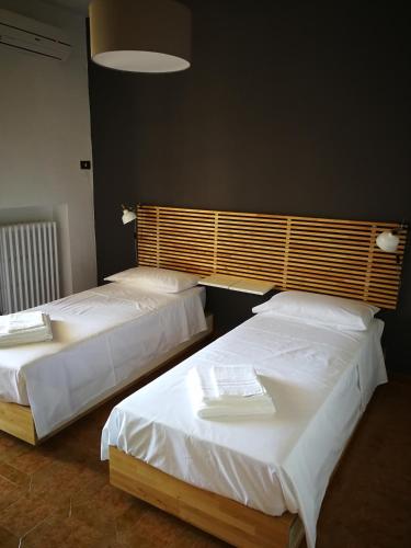 two beds in a room with white sheets at Villa Ramolina - Metaponto in Metaponto