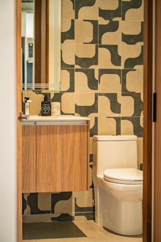 a bathroom with a toilet and a sink at Pacific Surfside Ocean Views in Surf City in ChiltiupÃ¡n