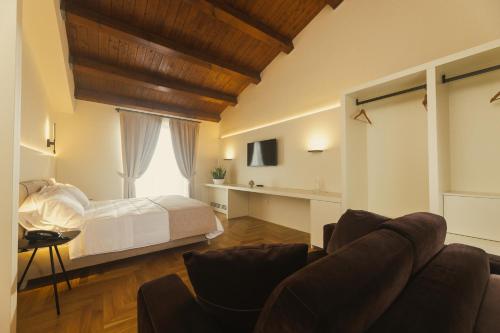 a living room with a bed and a couch at Masseria Pietrafitta in Foggia