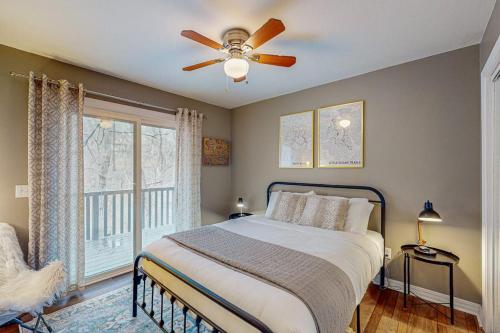 a bedroom with a bed and a ceiling fan at The Loblolly in Bella Vista