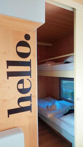 two bunk beds in a room with a sign on the wall at CHIC Riverfront Retreat with Private Jacuzzi, BIG BERRY in Gradac