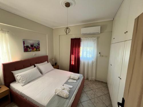 a bedroom with a bed with two towels on it at Windmill view apartment in Antimácheia