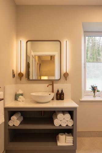 a bathroom with a sink and a mirror at The Residence Ashford in Cong