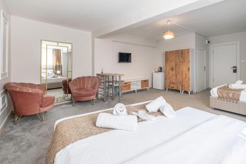 a bedroom with two beds and a living room at Oban Suites Istanbul in Istanbul