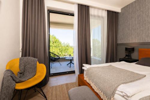 a hotel room with a bed and a balcony at B&B Plitvice Lacus in Seliste Dreznicko