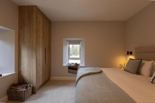 a bedroom with a large bed and a window at The Residence Ashford in Cong
