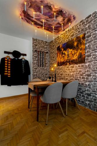 a dining room with a table and chairs and a brick wall at Wizard's apartment Plovdiv in Plovdiv