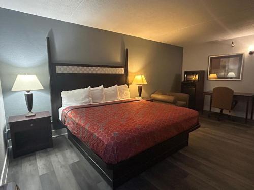 a hotel room with a bed and a chair at Key Inn Roseville in Roseville