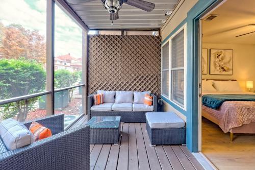 a screened in porch with a bed and a couch at Alpine Studio in Helen