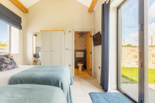 a bedroom with a bed and a large window at 3 Bed in Wendron oc-w29093 in Wendron